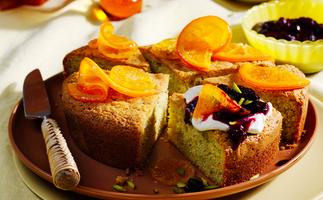 Olive oil pistachio cake topped with candied oranges and a generous dollop of crème fraîche and berry compote. 